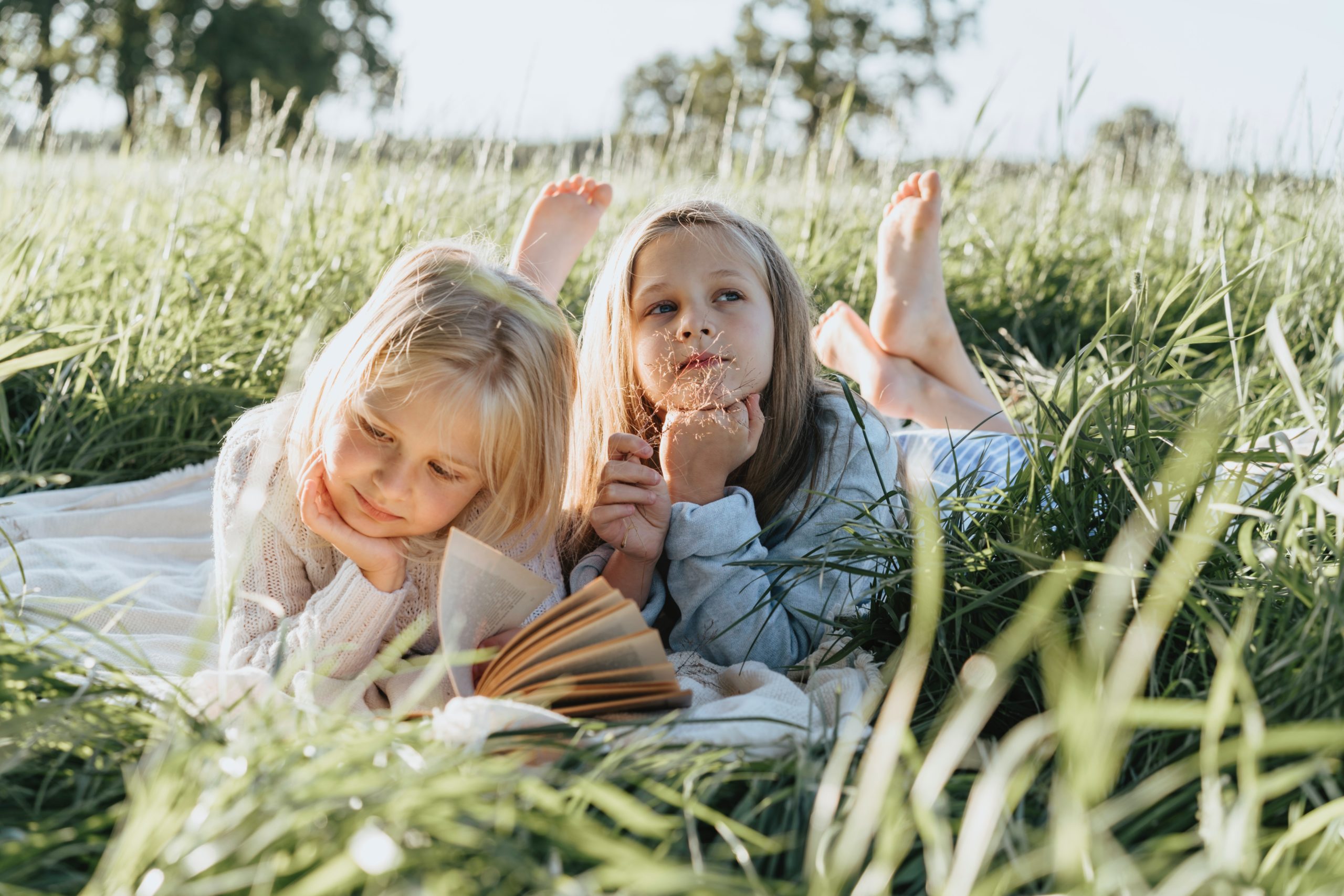 Two young sisters in grass